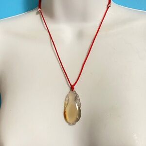 Carved Natural Agate Pendant On Red Silk Cording